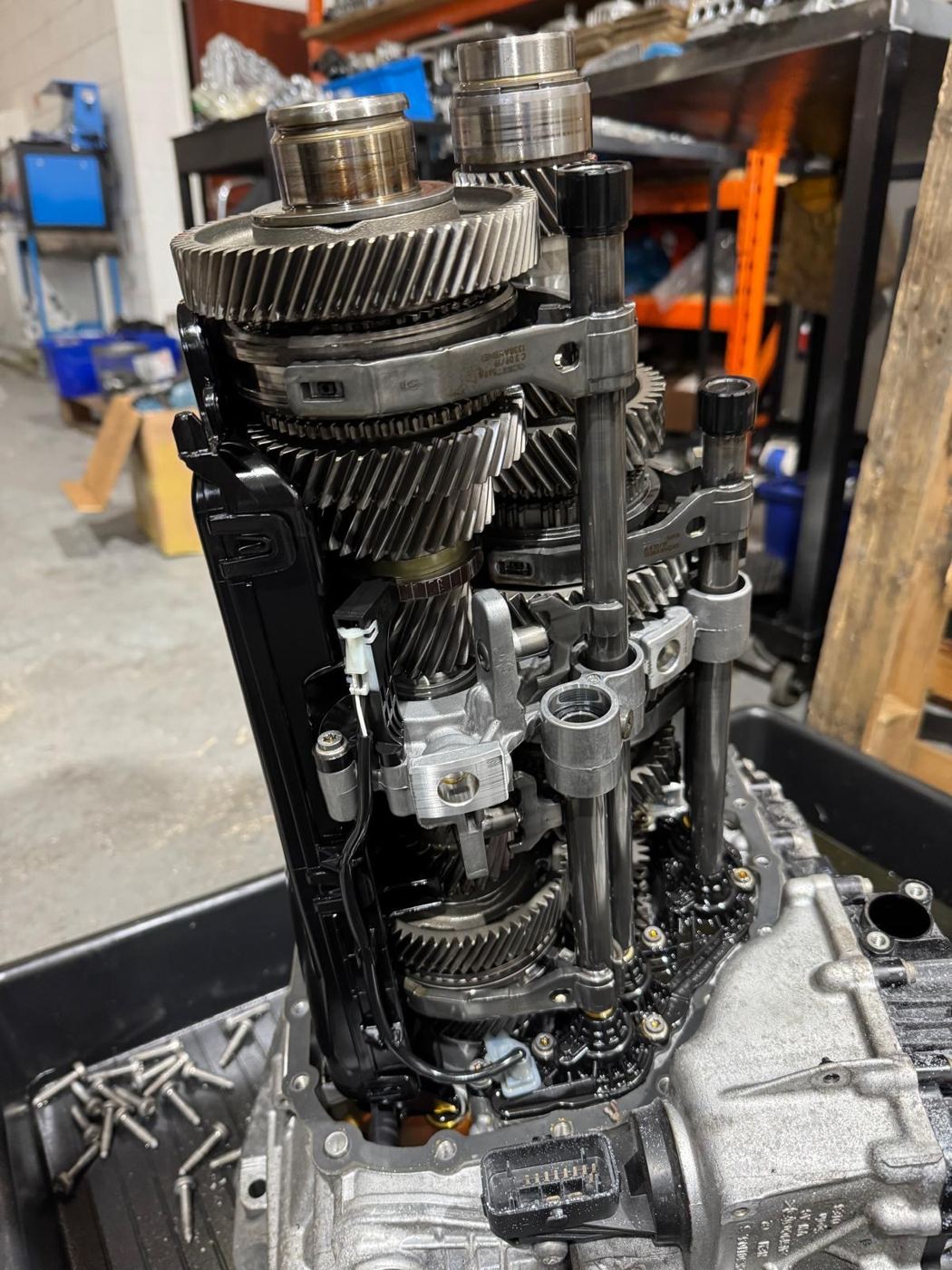 Dual-clutch gearbox gearset with clutch packs exposed during a rebuild